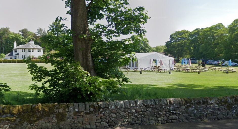 Beer tent and wooden benches in parkland off Kinross main street