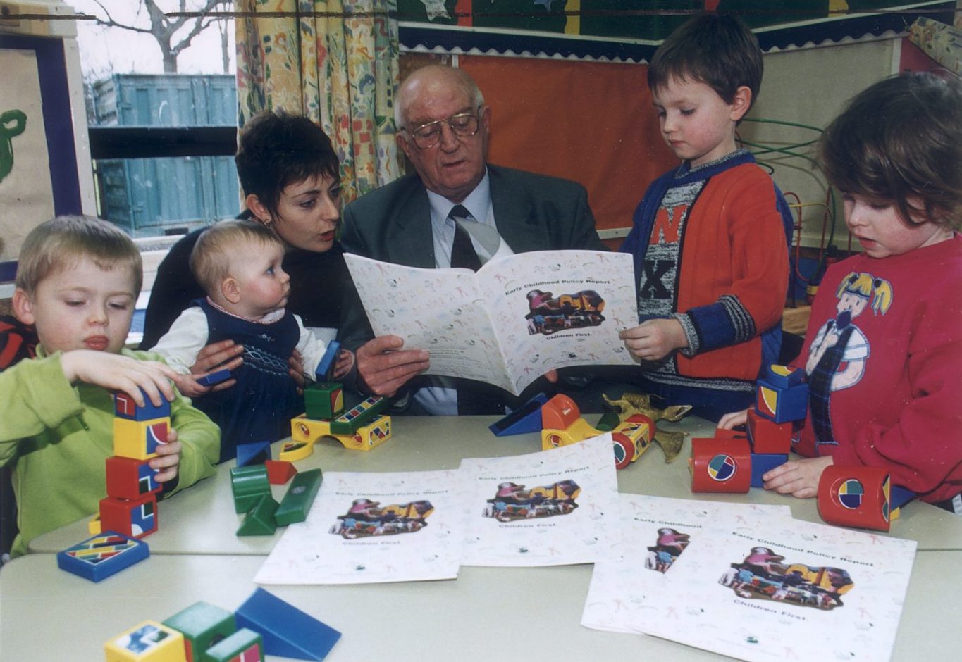 Councillor Kelly reading up on the policy with some nursery pupils