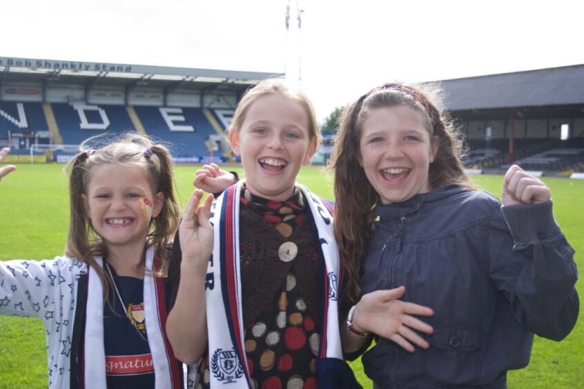 three happy fans at Dens Park in 2009