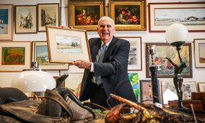 Ian Taylor holds up a watercolour by King Charles III which features in an upcoming auction. Mhairi Edwards/DC Thomson