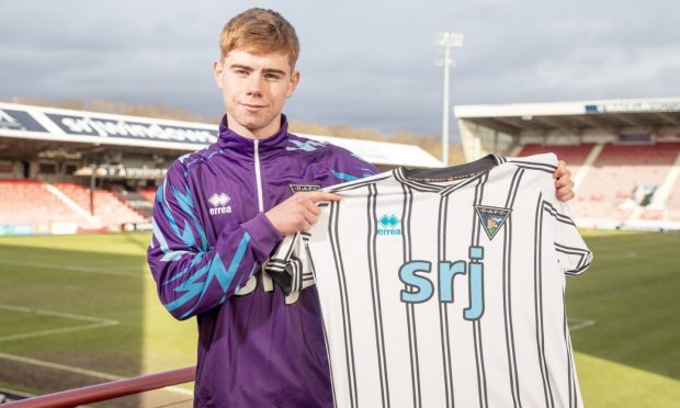 New Dunfermline recruit Keith Bray at East End Park, holding up a Dunfermline Athletic shirt