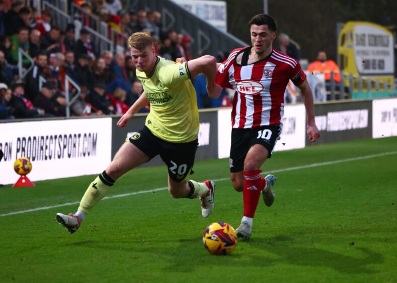 Zach Mitchell in action for Charlton, running past an opponent with the ball