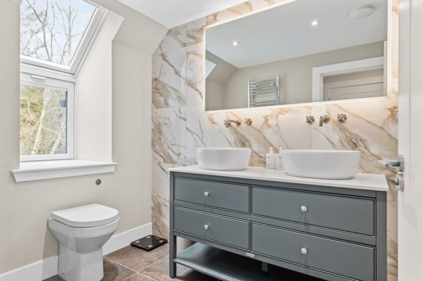 The master en-suite features dual basins.