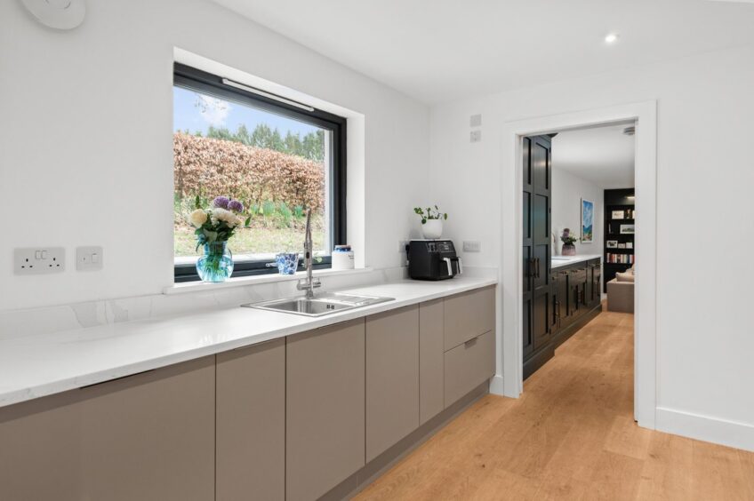 A separate utility rooms sits off the kitchen