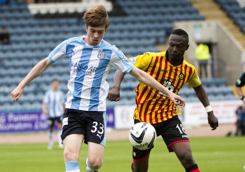 dundee FC striker Craig Wighton on the ball as an opponent closes him down