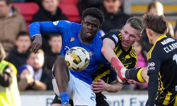 Benji Kimpioka battles for the ball against Aberdeen.