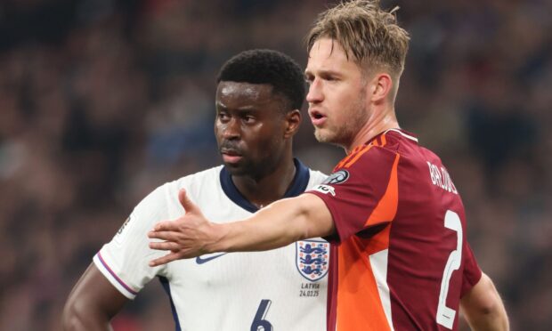 Daniels Balodis marks England's Mark Guehi.