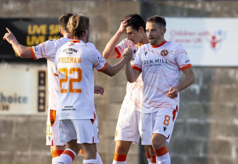 Four United players in the away kit during a game in July 2021