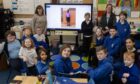 Friends of Toowa trustee Rhona Guild (left) with Aberlemno pupils and teacher Jill Brown. Image: Paul Reid