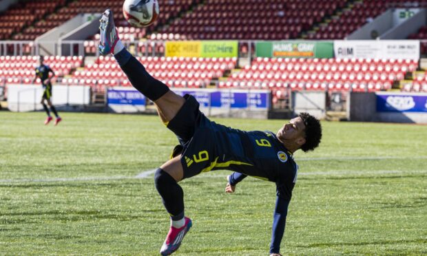 Caelen Cadamarteri with an acrobatic effort for Scotland.