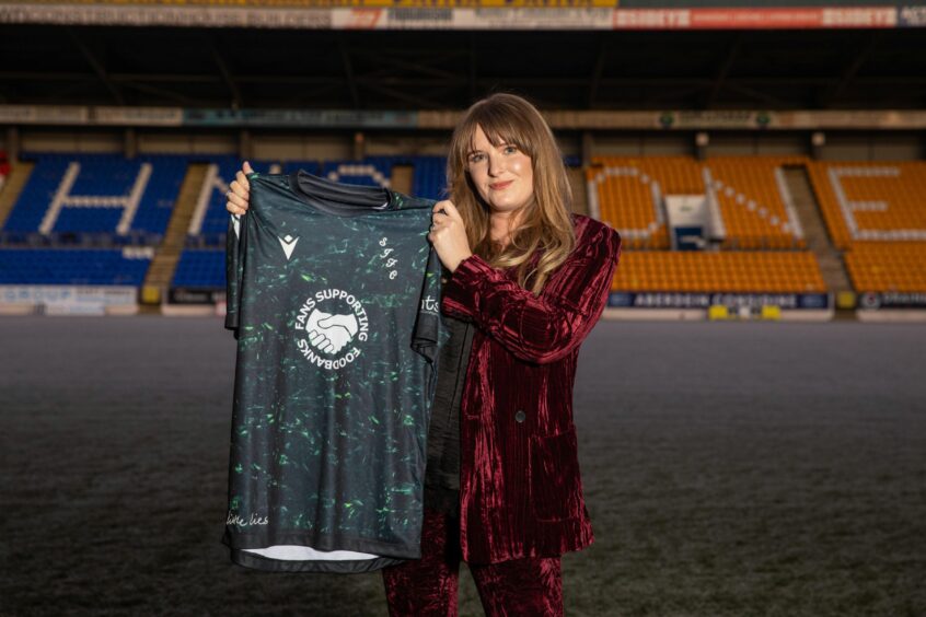Fashion designer Jade Robertson unveils the Saints' charity strip on the McDiarmid Park pitch in December 2024.