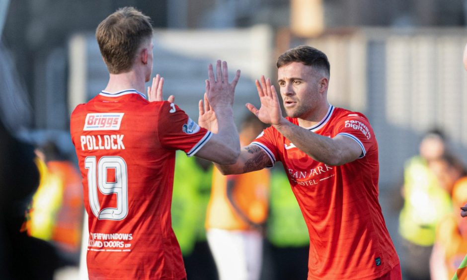 Finlay Pollock and Lewis Vaughan exchange high fives as they swap places for Raith Rovers.