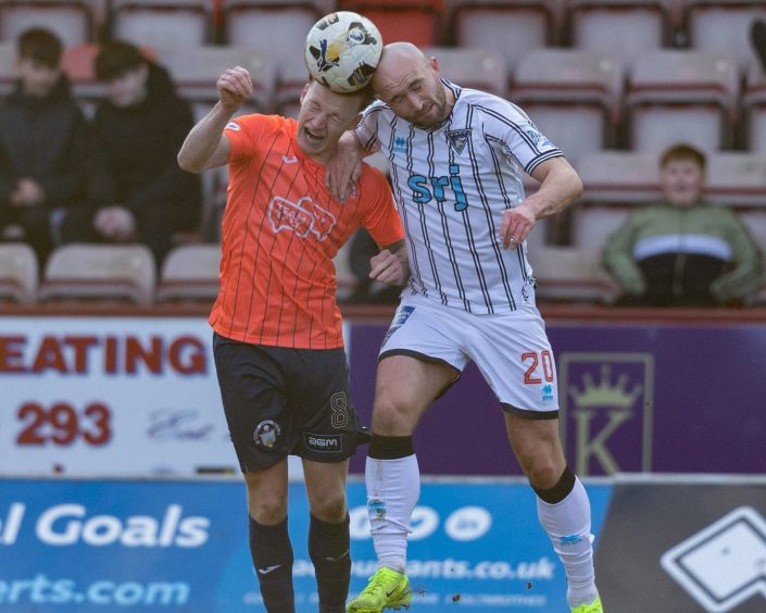 Chris Kane challenges for a header against Morton.