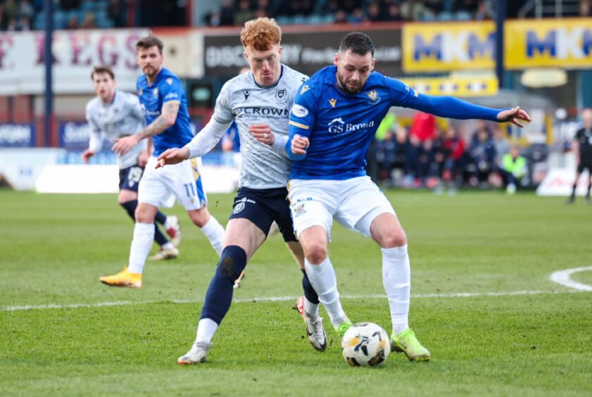 Drey Wright holds off Dundee's Simon Murray.