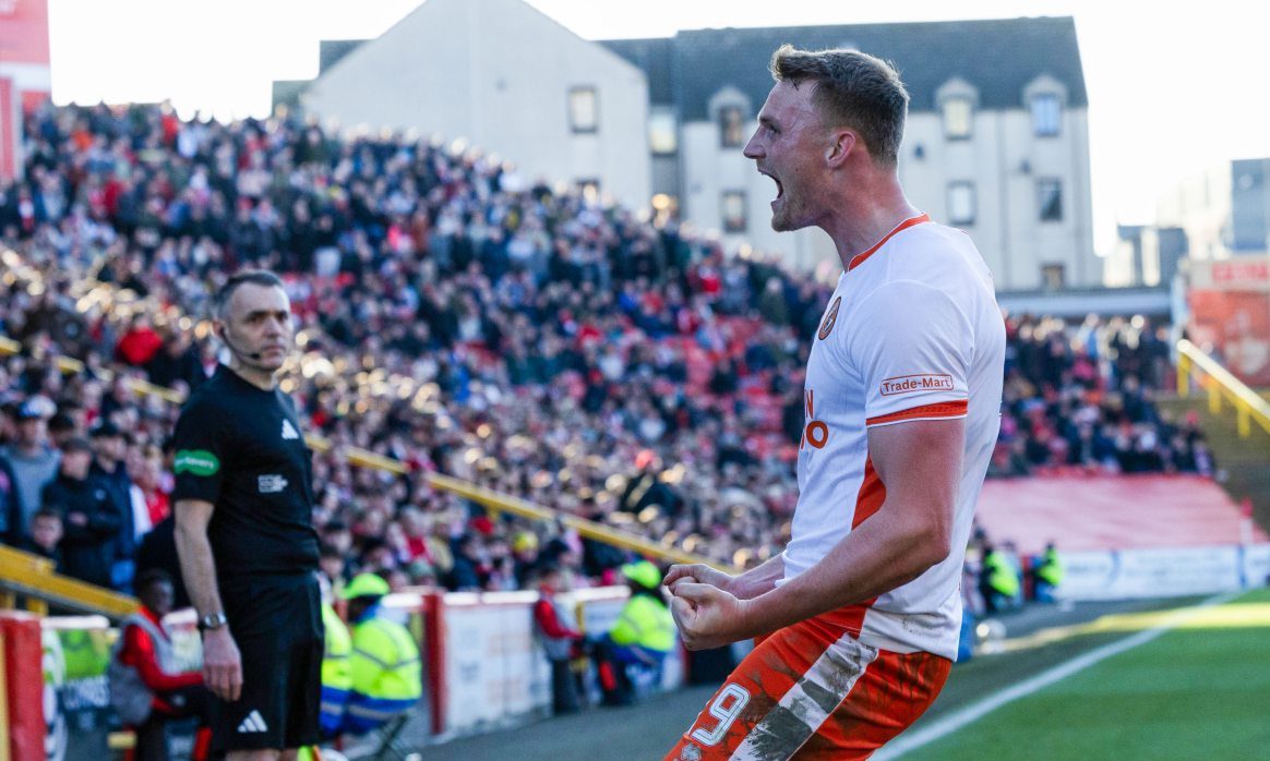 Sam Dalby roars with delight in front of the Dundee United fans at Pittodrie