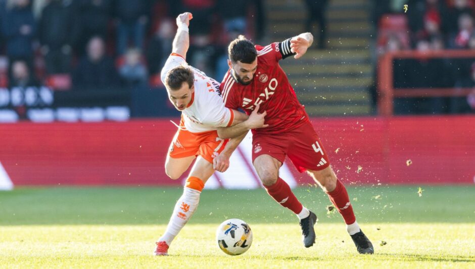 Kristijan Trapanovski battles for possession at Pittodrie.