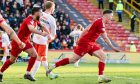 Nisbet wheels away after breaking United hearts