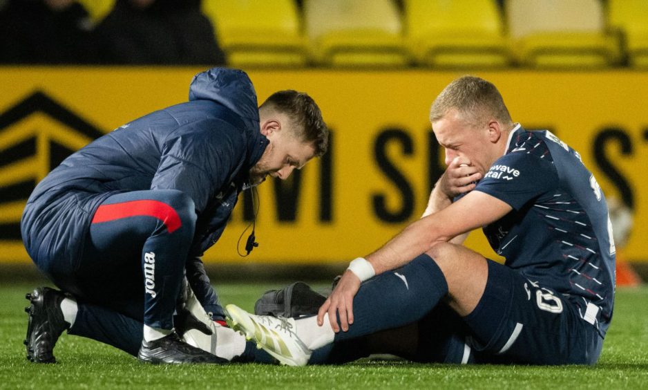 Raith Rovers captain Scott Brown receives treatment as he sits down.