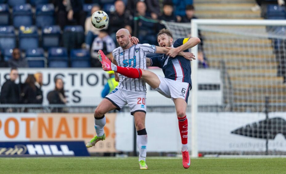 Dunfermline striker Chris Kane challenges for a high ball with Falkirk's Coll Donaldson.