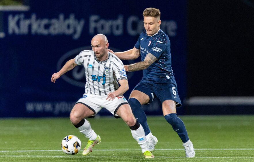 Dunfermline striker Chris Kane shields the ball from Raith Rovers defender Euan Murray.