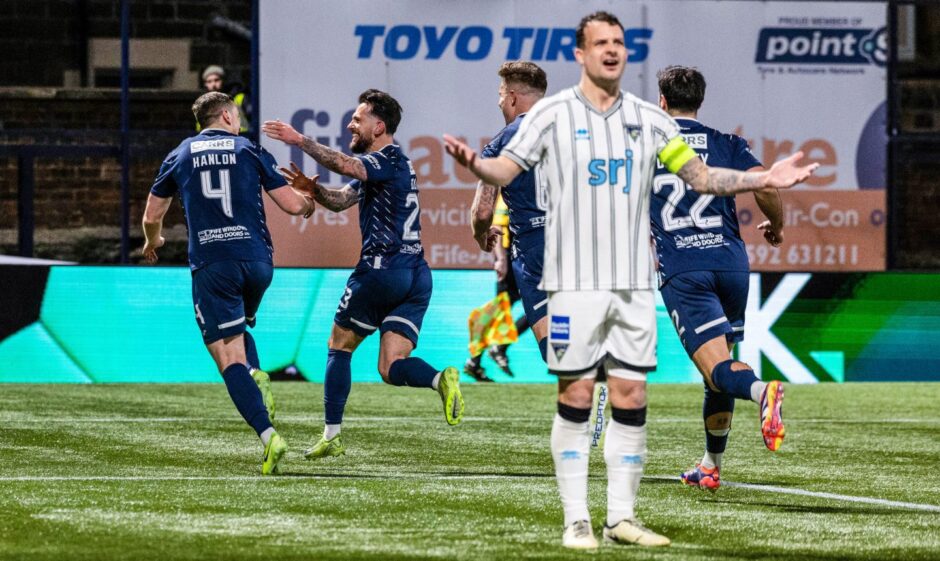 As Paul Hanlon runs away with team-mates to celebrate Raith Rovers' second goal in the Fife derby, Dunfermline Athletic captain Kyle Benedictus holds out his hands.