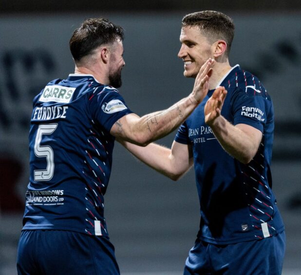 Callum Fordyce and Paul Hanlon are all smiles as they celebrate together.