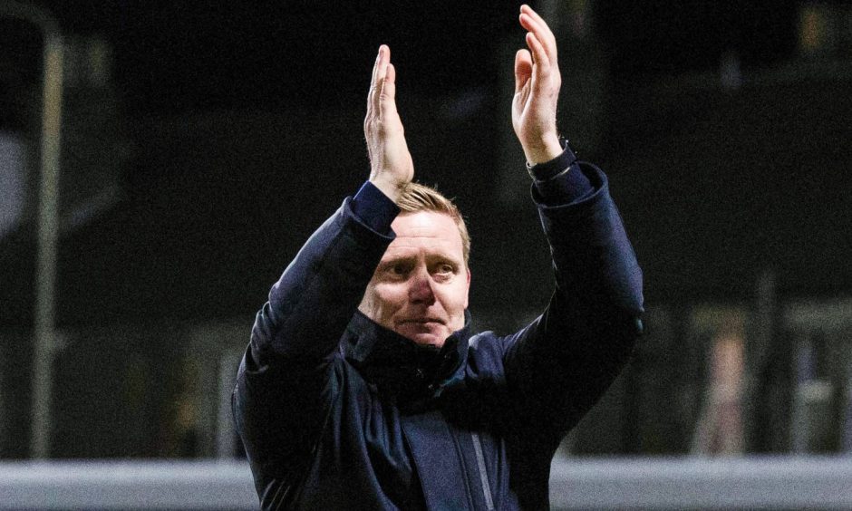 Barry Robson claps his hands facing the Raith Rovers supporters.