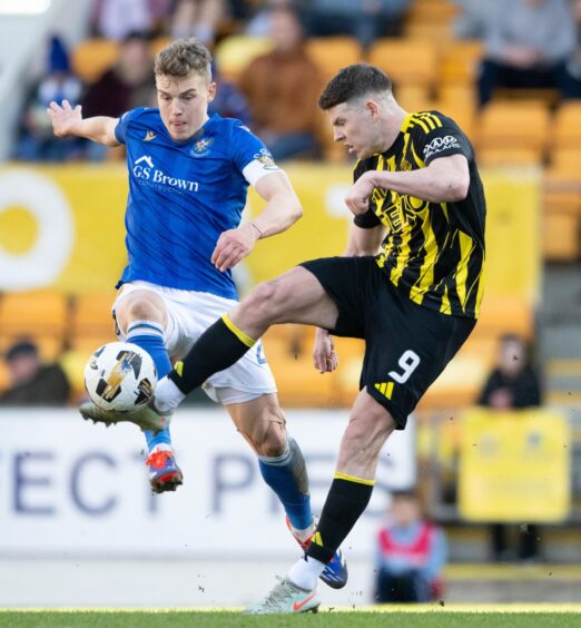 Sven Sprangler and Kevin Nisbet battle for the ball.