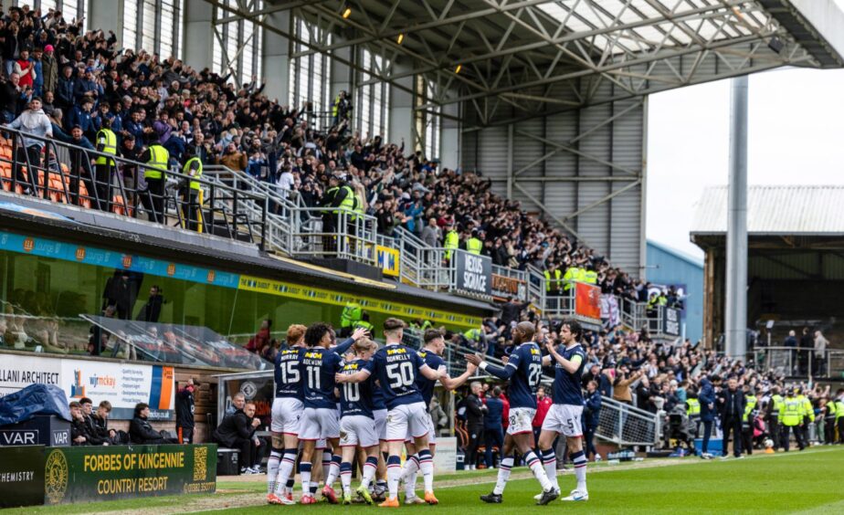 Dundee celebrate in front of away fans after Scott Tiffoney made it 3-1. Image: Ross Parker/SNS