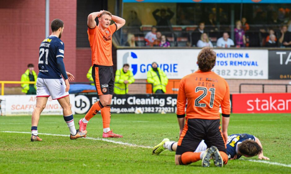 Dundee United players see another chance pass by.