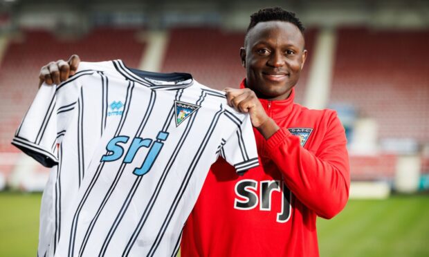 Victor Wanyama holds up a Dunfermline Athletic top.