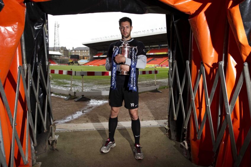 Mihael Kovacevic clutches the Scottish Cup at Tannadice