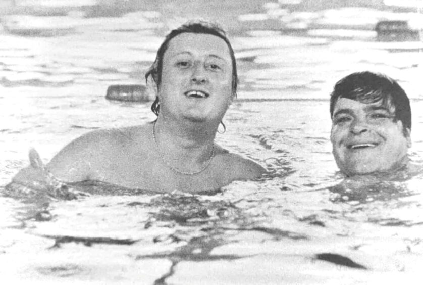 Eric and Jocky enjoying a splash in a swimming pool