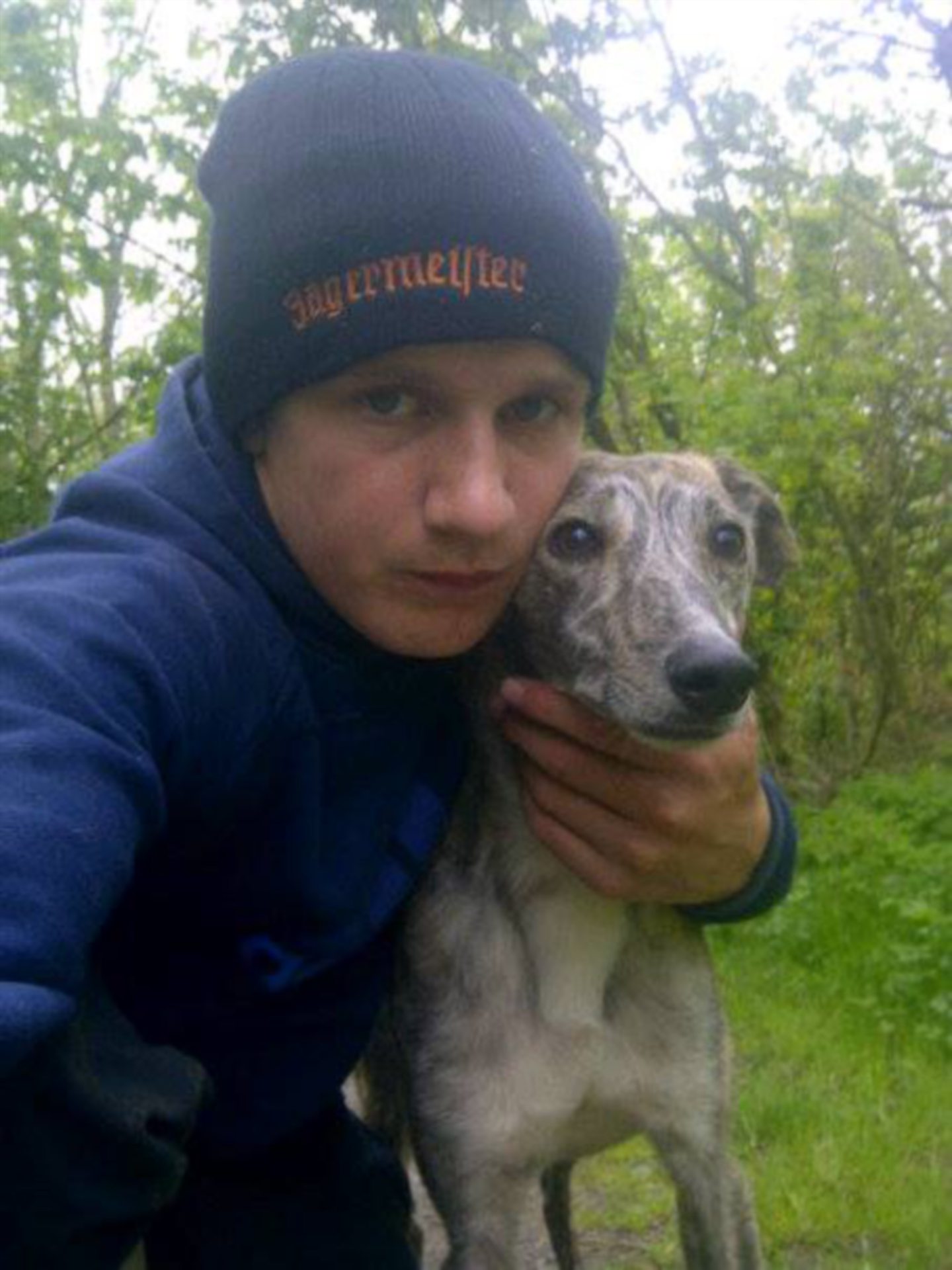 Brandon Robb, aged 17, with his pet lurcher dog. 