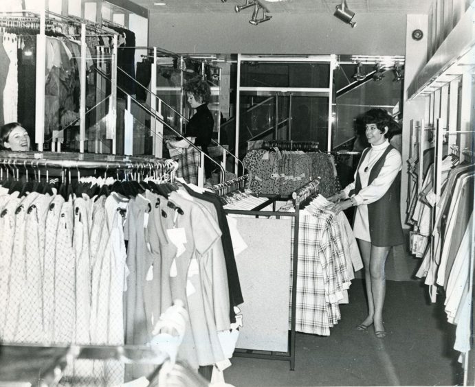 two female staff members beside clothes in Dundee store Van Allan in April 1970.