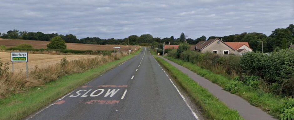 Sign forBlairforge with a few bungalows and surrounding countryside