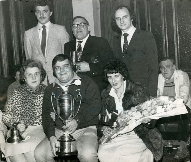 Jocky and Malvina Wilson and others with the world championship trophy in January 1982.