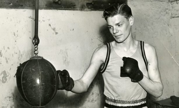 Dick McTaggart punching the bag in April 1954. Image: DC Thomson.