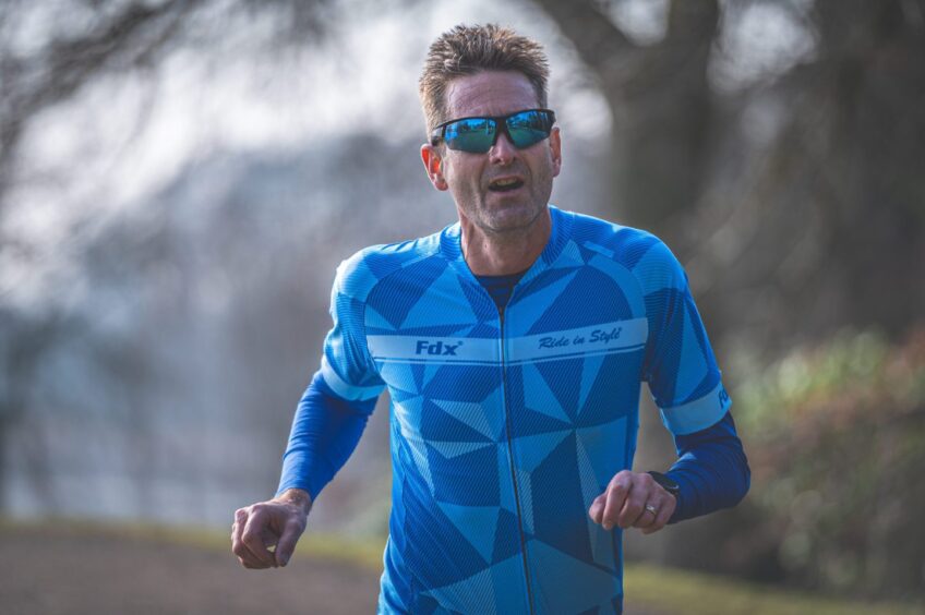 A man wears sunglasses during the duathlon. 