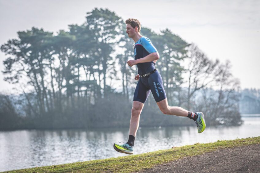 A man runs through Monikie Country Park. 