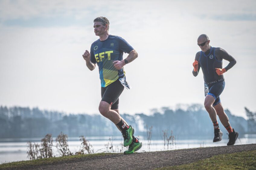 Two men run in Monikie Country Park