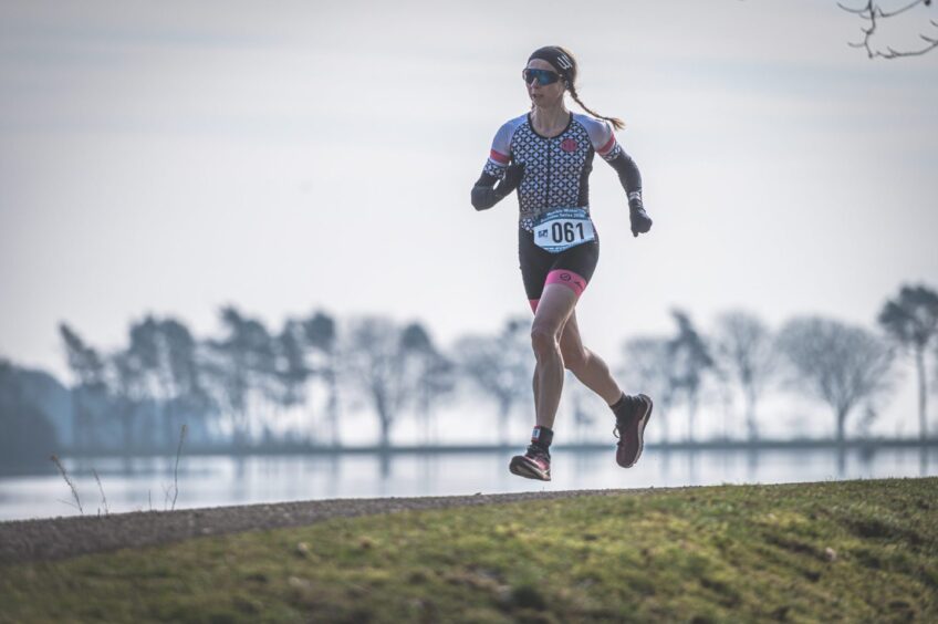 A woman looks like she is running on air during the duathlon. 