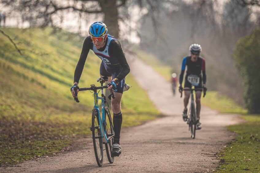 Two cyclists ride through Monikie Country Park during the Duathlon. 