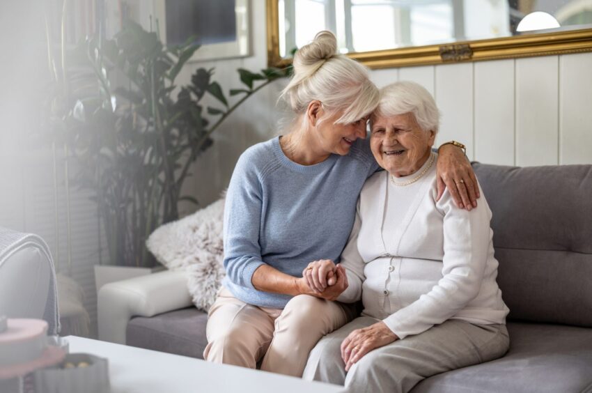 Adult daughter supporting her elderly mum.