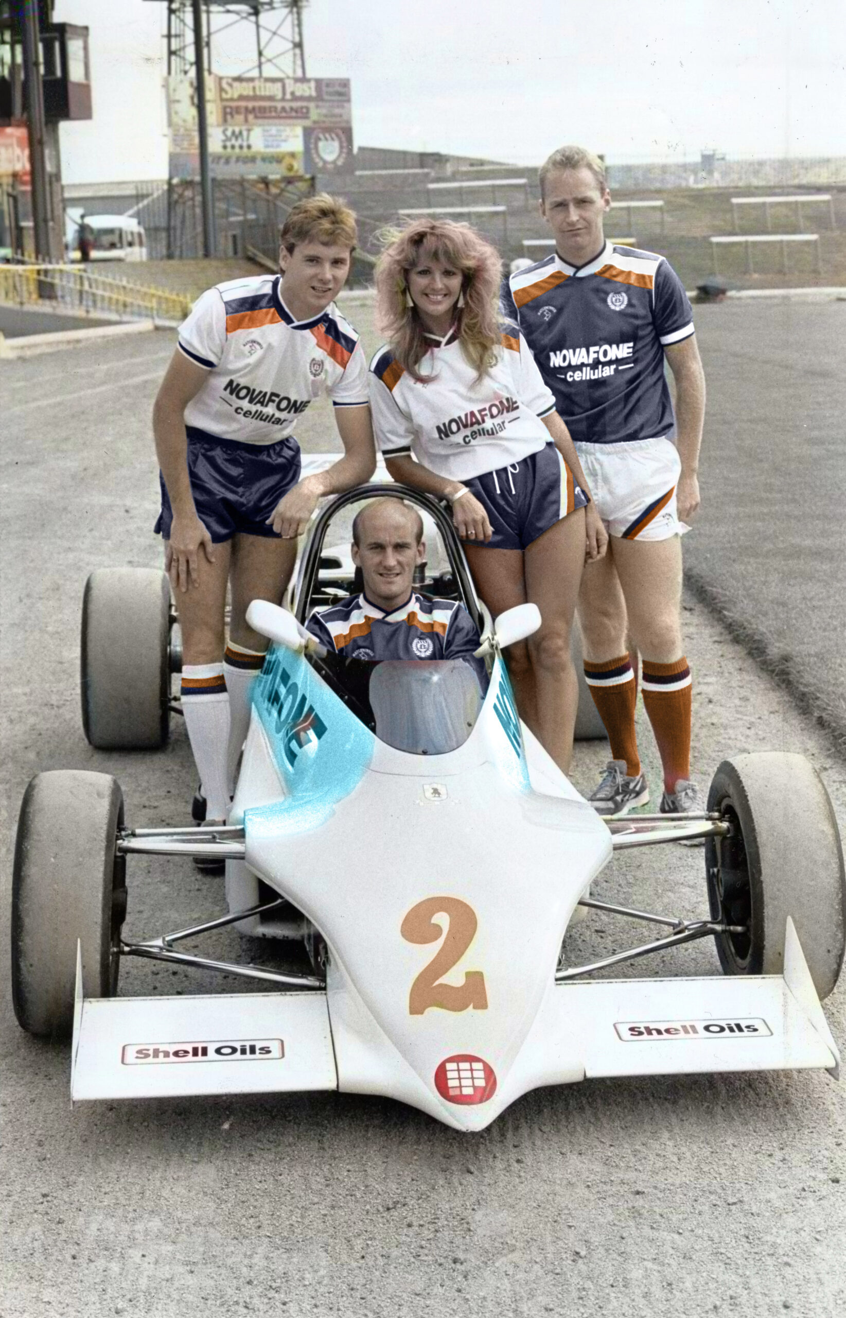 Marie Traynor, Tommy Coyne, John Brown and Jim Duffy in Dundee FC kits in 1987, with Jim sitting inside a small pedal race car