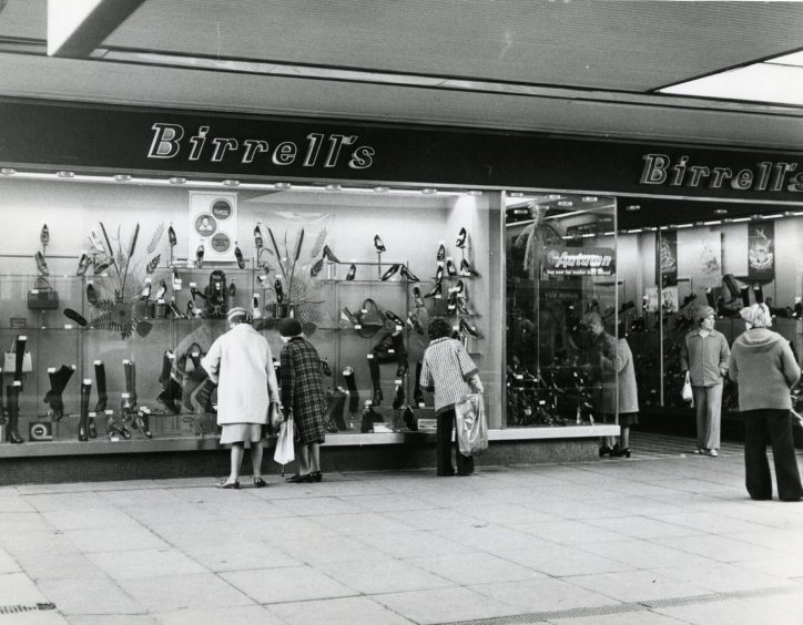 people at the exterior of Birrell's shoe shop. 