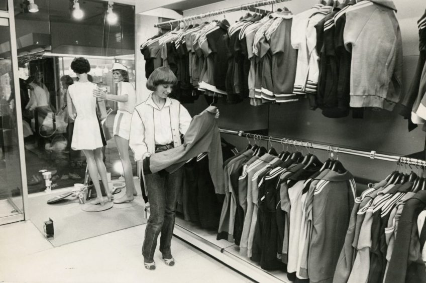 A female shopper looking through the range at Caird Sports Locker in June 1980.