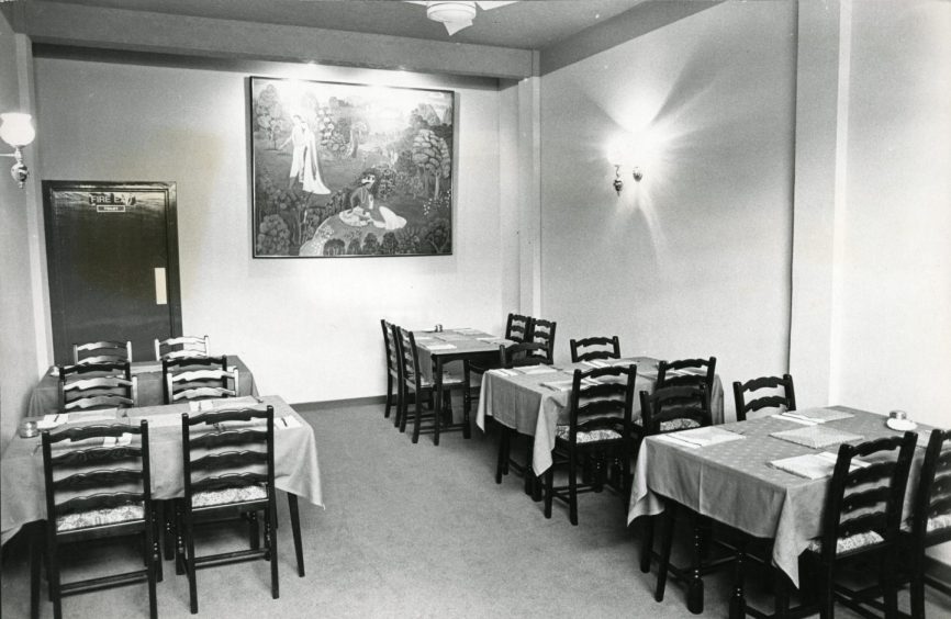 Tables and chairs inside Gunga-Din restaurant in Dundee