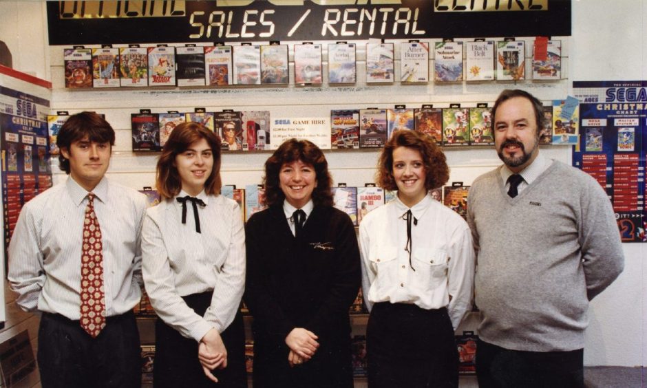 Visions Video Shop staff in front of a wall of VHS tapes in the Perth Road store in December 1992. 