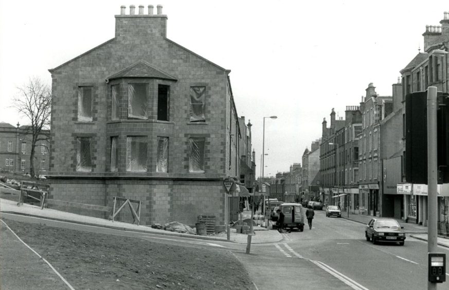 The tenement gable at the Sinderins junction during work in April 1987.